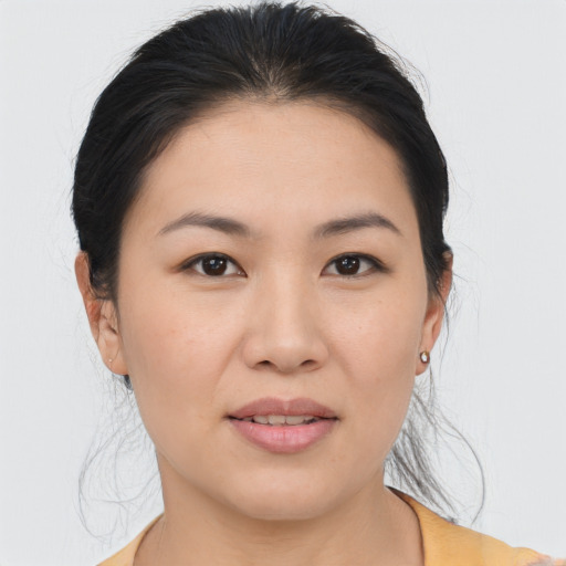 Joyful asian young-adult female with medium  black hair and brown eyes