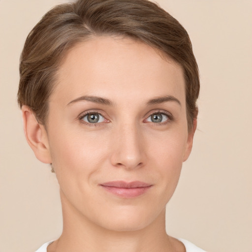 Joyful white young-adult female with short  brown hair and grey eyes