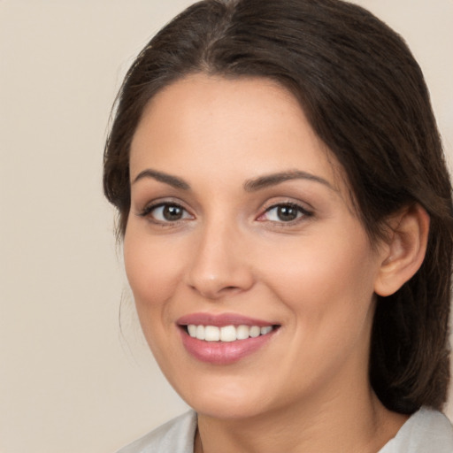 Joyful white young-adult female with medium  brown hair and brown eyes