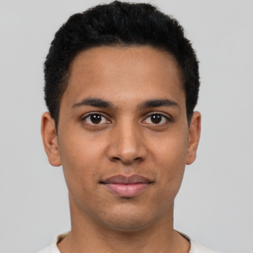 Joyful latino young-adult male with short  brown hair and brown eyes