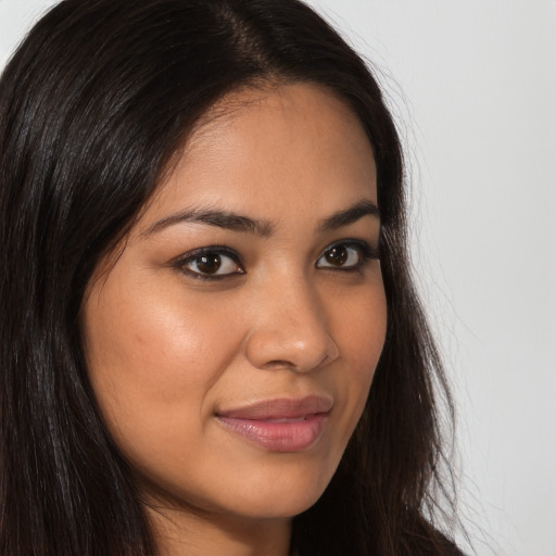 Joyful latino young-adult female with long  brown hair and brown eyes