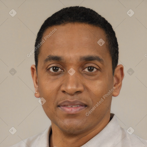 Joyful black adult male with short  black hair and brown eyes