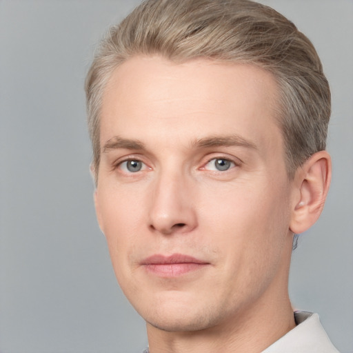 Joyful white adult male with short  brown hair and grey eyes