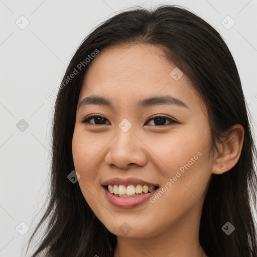 Joyful asian young-adult female with long  brown hair and brown eyes