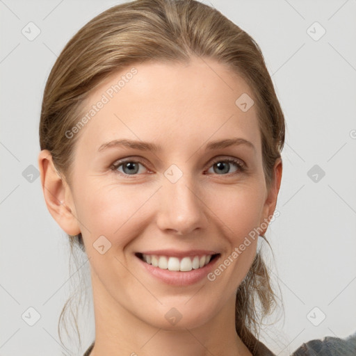 Joyful white young-adult female with medium  brown hair and grey eyes