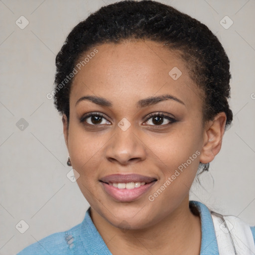 Joyful black young-adult female with short  black hair and brown eyes