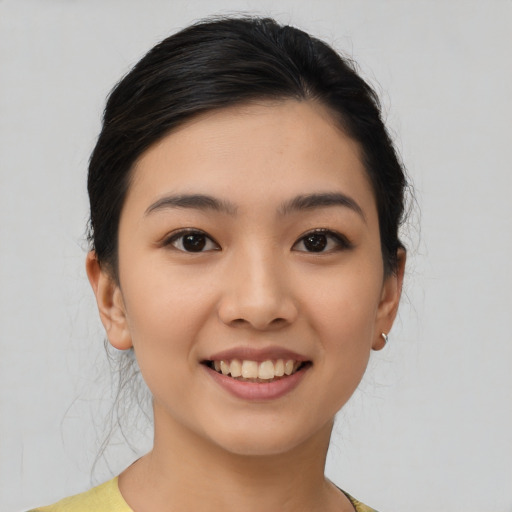 Joyful asian young-adult female with medium  black hair and brown eyes