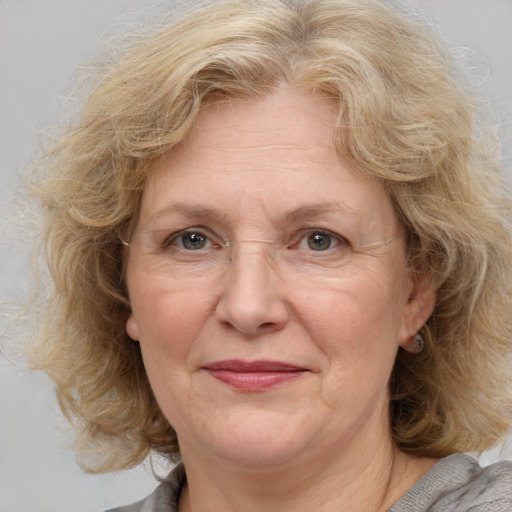 Joyful white middle-aged female with medium  brown hair and blue eyes