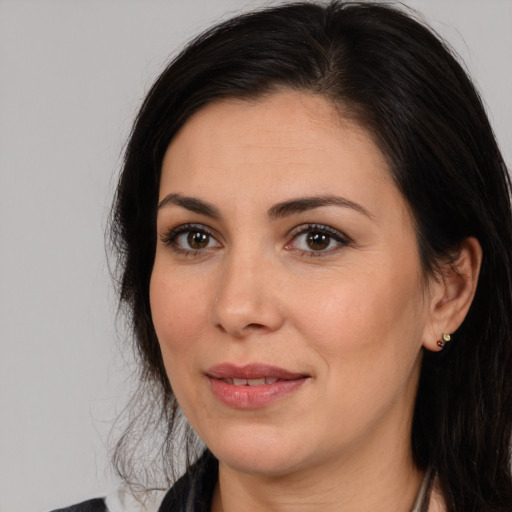 Joyful white adult female with medium  brown hair and brown eyes