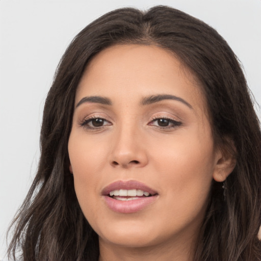 Joyful white young-adult female with long  brown hair and brown eyes