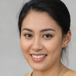 Joyful asian young-adult female with medium  brown hair and brown eyes