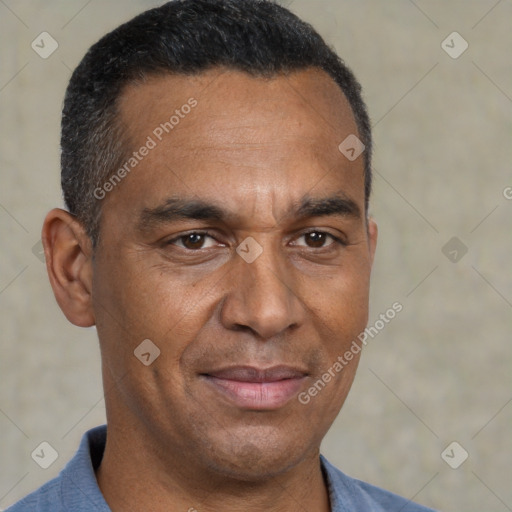 Joyful black adult male with short  brown hair and brown eyes