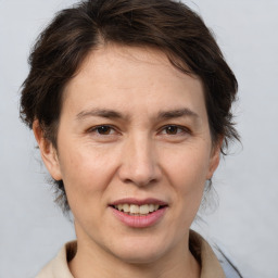 Joyful white adult female with medium  brown hair and brown eyes