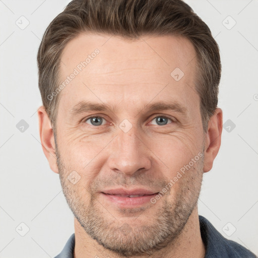 Joyful white adult male with short  brown hair and grey eyes