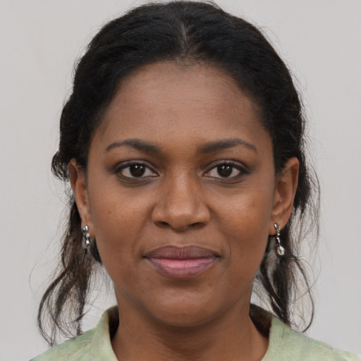 Joyful black young-adult female with medium  brown hair and brown eyes