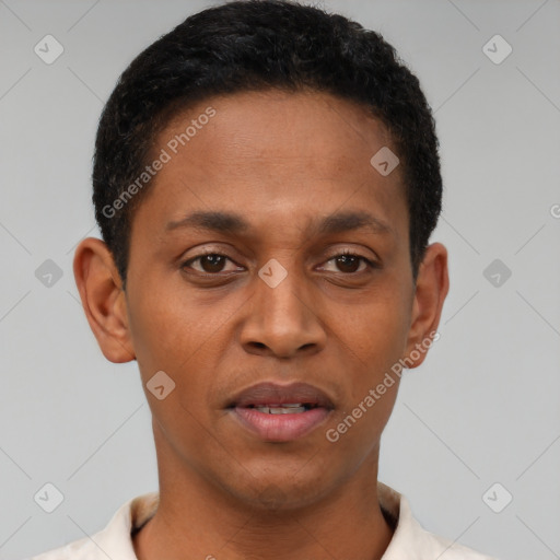 Joyful black young-adult male with short  brown hair and brown eyes