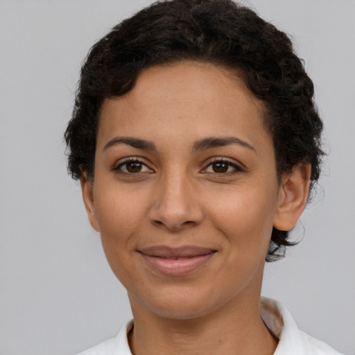 Joyful latino adult female with short  brown hair and brown eyes