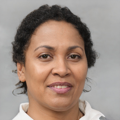 Joyful latino adult female with short  brown hair and brown eyes