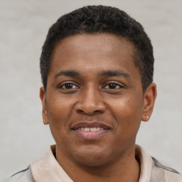 Joyful latino young-adult male with short  black hair and brown eyes