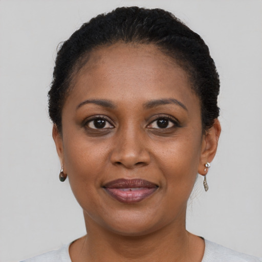 Joyful black adult female with short  brown hair and brown eyes