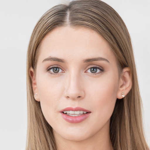 Joyful white young-adult female with long  brown hair and grey eyes