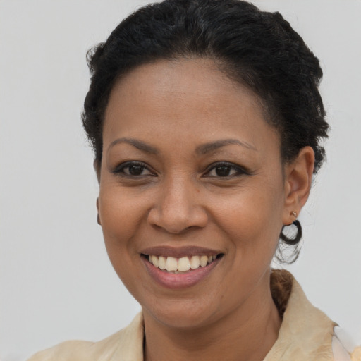 Joyful latino adult female with short  brown hair and brown eyes