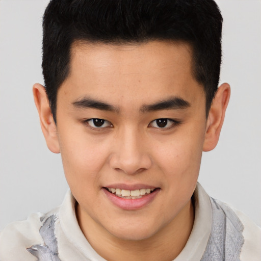 Joyful asian young-adult male with short  brown hair and brown eyes