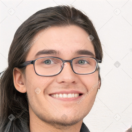 Joyful white young-adult male with long  brown hair and brown eyes