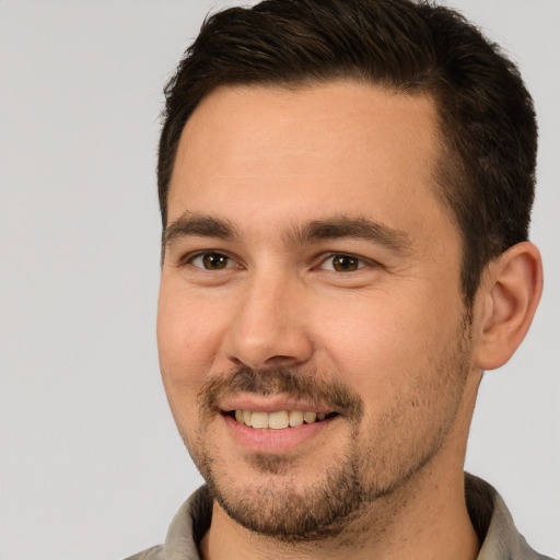 Joyful white adult male with short  brown hair and brown eyes