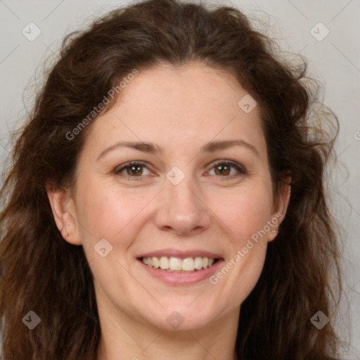 Joyful white adult female with long  brown hair and brown eyes