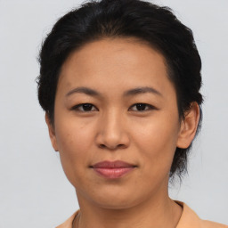 Joyful asian young-adult female with short  brown hair and brown eyes