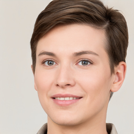 Joyful white young-adult female with short  brown hair and grey eyes