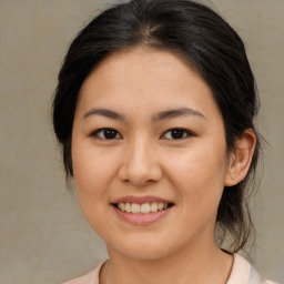 Joyful asian young-adult female with medium  brown hair and brown eyes