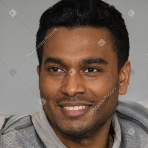 Joyful latino young-adult male with short  black hair and brown eyes