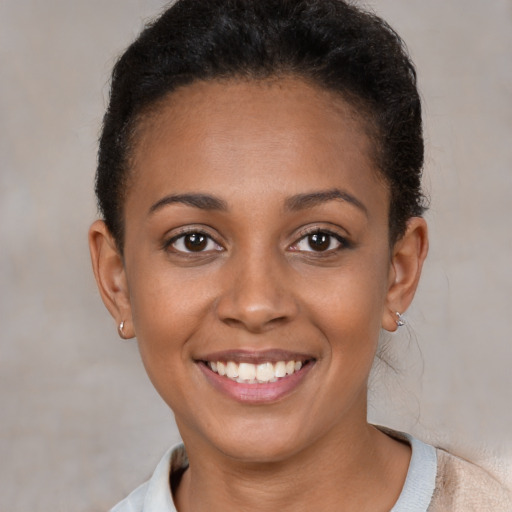 Joyful latino young-adult female with short  brown hair and brown eyes