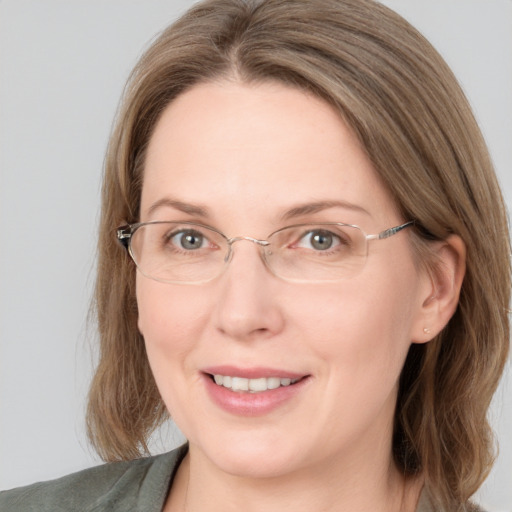 Joyful white adult female with medium  brown hair and grey eyes