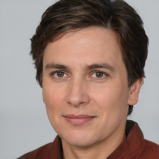 Joyful white adult male with medium  brown hair and brown eyes