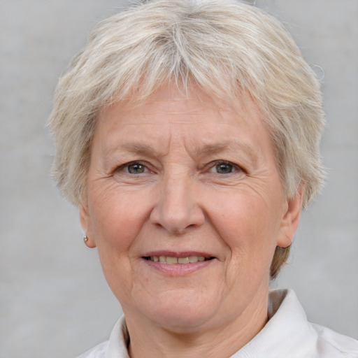 Joyful white middle-aged female with short  gray hair and grey eyes