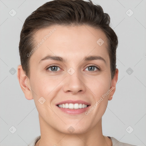 Joyful white young-adult female with short  brown hair and grey eyes