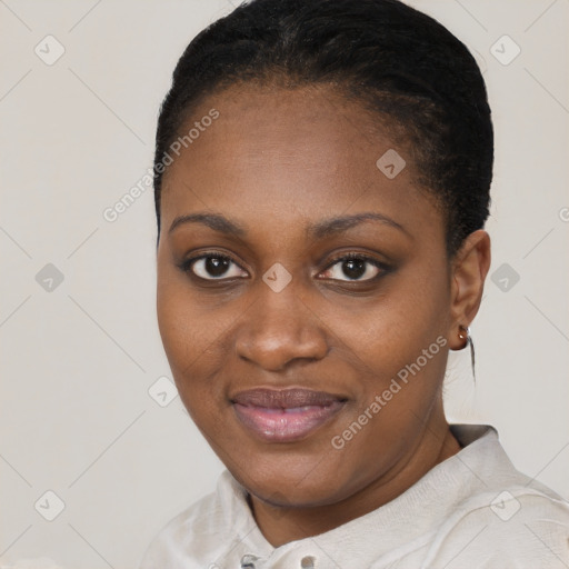 Joyful black young-adult female with short  black hair and brown eyes