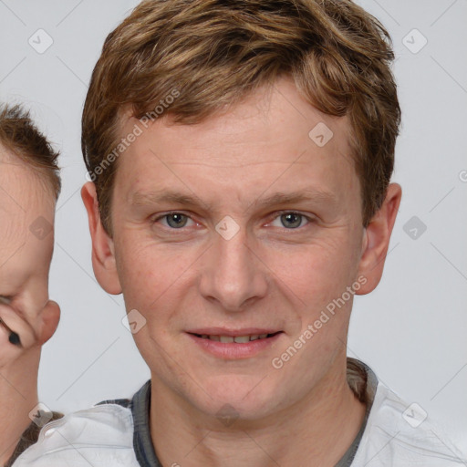 Joyful white adult male with short  brown hair and brown eyes