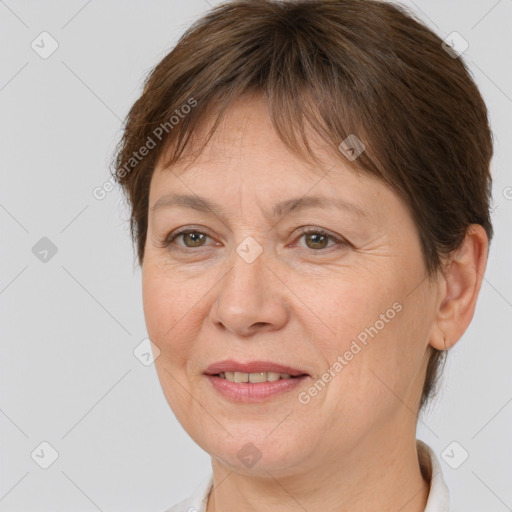 Joyful white adult female with short  brown hair and brown eyes