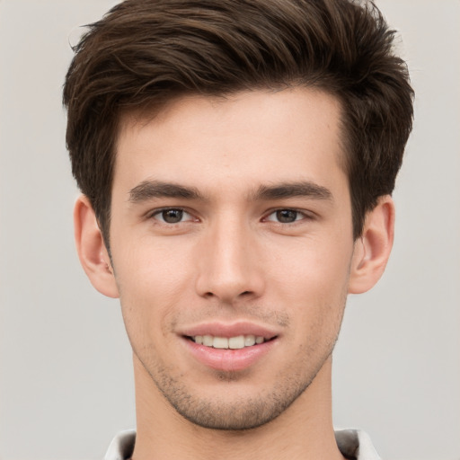 Joyful white young-adult male with short  brown hair and brown eyes