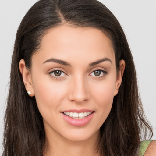 Joyful white young-adult female with long  brown hair and brown eyes