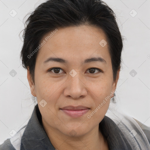 Joyful asian adult female with medium  brown hair and brown eyes