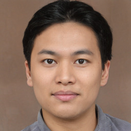 Joyful asian young-adult male with short  brown hair and brown eyes