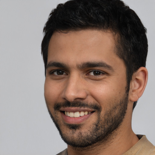 Joyful white young-adult male with short  black hair and brown eyes