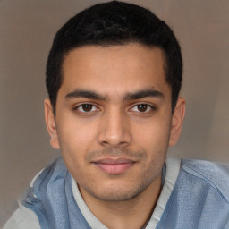 Joyful latino young-adult male with short  brown hair and brown eyes