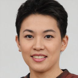 Joyful asian young-adult female with short  black hair and brown eyes