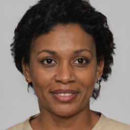 Joyful black adult female with short  brown hair and brown eyes